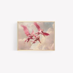 May include: A framed print featuring three pink monkeys with large, feathered wings, soaring through a cloudy sky. The artwork has a vintage aesthetic with soft colors and a gold frame, creating a whimsical and surreal scene.
