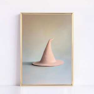 May include: A pale pink witch's hat with a pointed tip, framed in gold, against a light blue and beige background.