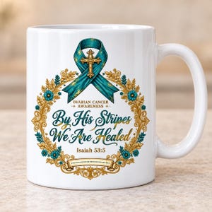 Pode incluir: Uma caneca de cerâmica branca com uma fita de conscientização azul-petróleo com uma cruz dourada, cercada por uma guirlanda floral dourada com flores azul-petróleo. O texto diz Ovarian Cancer Awareness, By His Stripes We Are Healed e Isaiah 53:5.