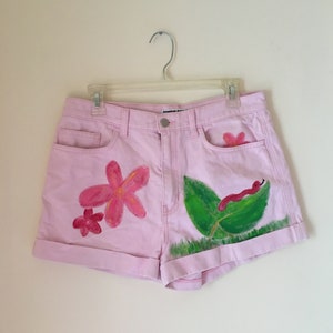 hand-painted american apparel pink shorts with flowers and a leaf and a little worm friend