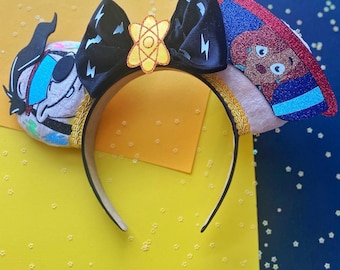 May include: A pair of pink Minnie Mouse ears with a black and white lightning bolt bow, a yellow atom symbol, and a blue and white character with a red shirt and a white hat.