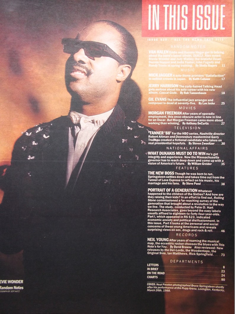 May include: A close-up portrait of Stevie Wonder, a famous singer and musician, wearing sunglasses and a white shirt with a black jacket. The image is from a magazine cover with the text "In This Issue" and "Random Notes" visible.