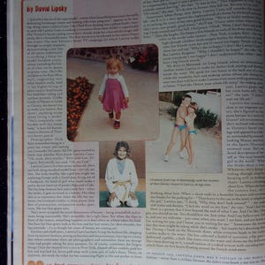 May include: A magazine article about Laetitia Casta, a French model. The article features several photos of Laetitia Casta at different ages, including a photo of her as a child wearing a pink dress, a photo of her as a teenager wearing a white karate uniform, and a photo of her as an adult wearing a black dress. The article discusses Laetitia Casta's career and her personal life.