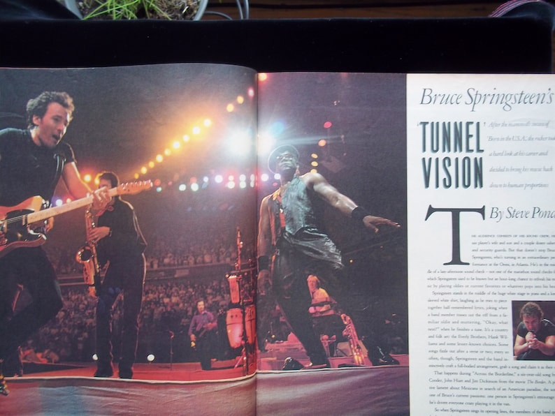 May include: A magazine page with a photo of Bruce Springsteen performing on stage with his band. The article is titled "Bruce Springsteen's Tunnel Vision" and discusses his music and career. The text in the article reads "After the monumental success of Born in the U.S.A., the reverberations of a hard-look album and a career dedicated to bringing for more hard drive is to human proportions."