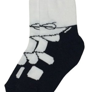 May include: White socks with a black and white geometric design. The socks are folded down to show the design.