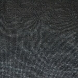 May include: A dark gray blazer with a subtle, fine white pinstripe pattern. The fabric has a textured, woven appearance.