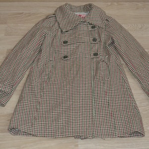 May include: A brown, red and white checked coat with a double-breasted closure and a large collar.