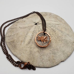 Coin and resin necklace. Pendant made from hand cut maple leaf and penny ring.