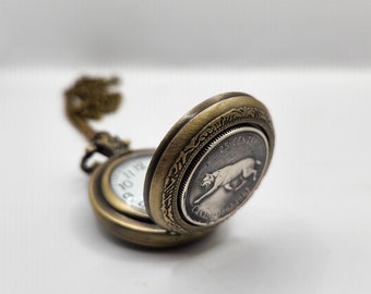 Pocket watch with silver centennial coin.