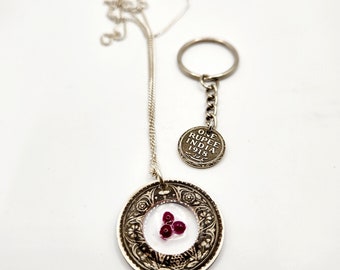 Silver Rupee coin necklace carved with resin and rubies.
