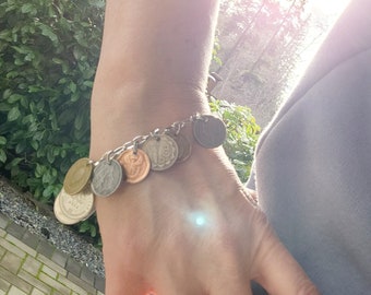Coin charm bracelet made from old coins from around the world.