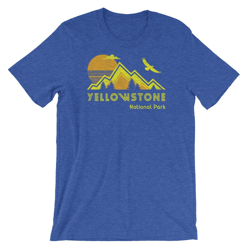 May include: A blue t-shirt with a yellow graphic of mountains, a sun, and a bird. The text "YELLOWSTONE National Park" is printed in yellow below the graphic.