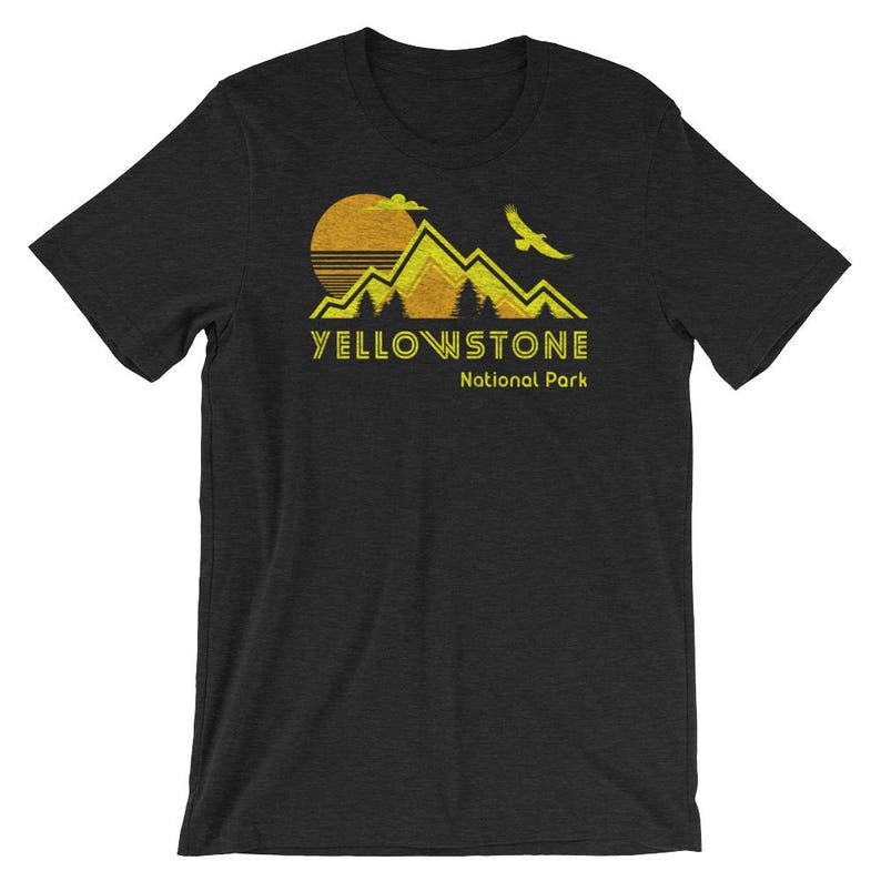 May include: Black t-shirt with a yellow graphic of mountains, a sun, and a bird. The text "Yellowstone National Park" is printed in yellow below the graphic.
