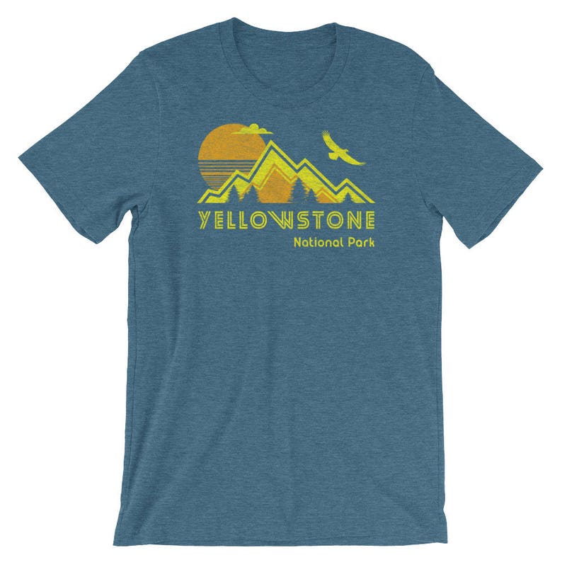 May include: A blue t-shirt with a yellow and orange graphic of mountains, a sun, and a bird. The text "Yellowstone National Park" is printed in yellow below the graphic.