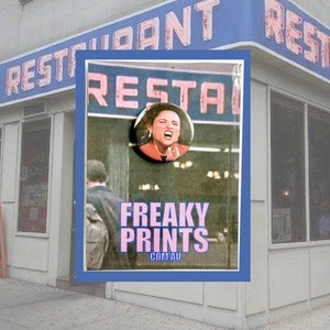 May include: Exterior shot of a restaurant with a blue and white sign that reads "TOM'S RESTAURANT". A framed image in the foreground features a woman's face and the text "FREAKY PRINTS .COM.AU".