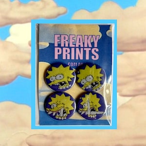 May include: Four round pins featuring a cartoon character with yellow hair and a purple background. The pins are packaged in a plastic bag with the text "FREAKY PRINTS COM.AU" printed on the front.