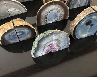May include: A set of eight agate bookends in various colours and patterns. The bookends are made of natural agate and have a polished finish. They are perfect for adding a touch of natural beauty to any bookshelf.
