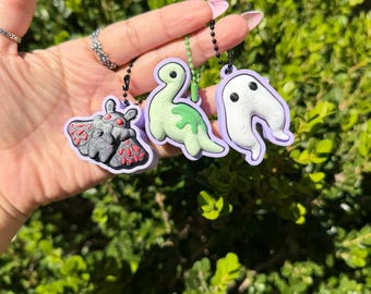 cryptid, moth, night crawler, nessie, spooky accessories, purse charms, fidget clickers, keychains
