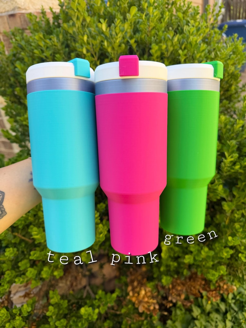 May include: Three insulated tumblers in teal, pink, and green. Each tumbler has a white lid with a colored accent and a silver band. The words "teal", "pink", and "green" are written below each tumbler.