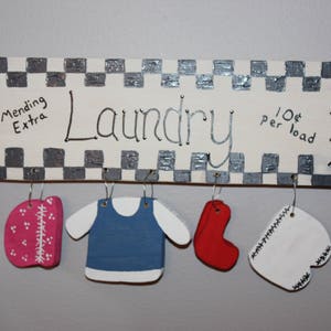 Hand painted wood Laundry sign.  This charming sign with a bonnet, shirt, pair of socks and bloomers adds charm to your laundry room.