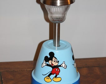 Hand painted clay flower pot solar light designed with 3 different Mickey Mouse poses.  This very decorative light is perfect for any area.