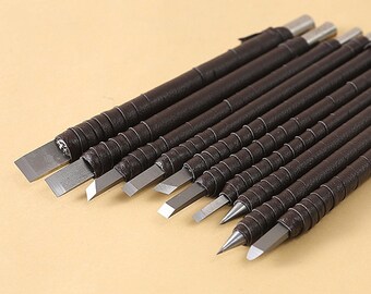 May include: A set of ten brown-handled carving tools with different shaped blades. The tools are arranged in a row, with the handles pointing to the right.