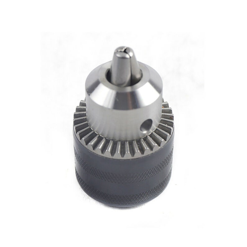 May include: A silver drill chuck with a black rubber grip. The chuck has a keyless design and a threaded end for attaching to a drill.