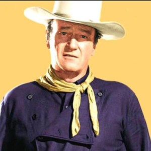 May include: A man wearing a white cowboy hat and a purple shirt with a yellow neckerchief.