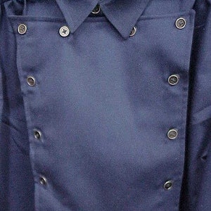 May include: A dark blue collared shirt with a double-breasted closure and multiple buttons.