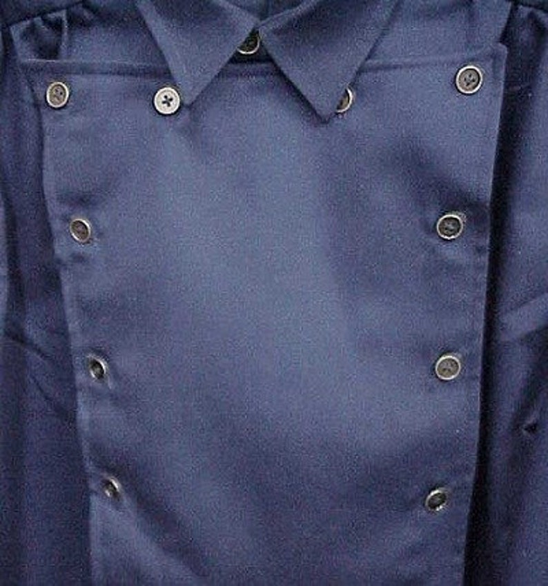 May include: A dark blue collared shirt with a double-breasted closure and multiple buttons.