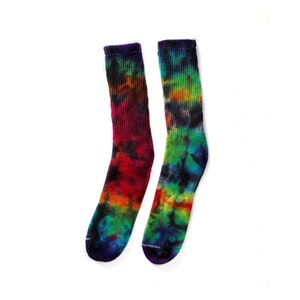 May include: A pair of colorful tie-dye socks with a rainbow pattern. The socks are made of a soft, comfortable material and are perfect for adding a pop of color to any outfit.