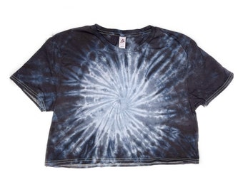 May include: A black and white tie-dye cropped t-shirt with a spiral design.