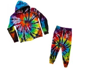 May include: A tie-dye hoodie and sweatpants set in a rainbow swirl pattern. The hoodie has a zip fastening and a hood. The sweatpants have an elastic waistband.