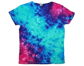 May include: A tie-dye t-shirt with a V-neck and short sleeves. The shirt is a mix of blue, green, and pink colors.