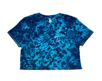 May include: A blue and green tie-dye cropped t-shirt with a white background.