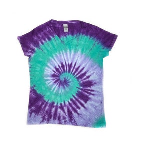 May include: A purple, green, and white tie-dye t-shirt with a v-neck.