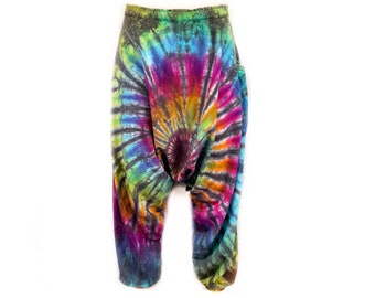 May include: A pair of colorful tie-dye pants with a swirling pattern in shades of blue, green, pink, orange, and black.