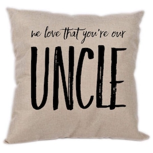 May include: Beige throw pillow with black text that reads "we love that you're our UNCLE".