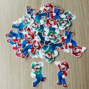 May include: A pile of colorful cartoon character stickers featuring Mario and Luigi. The stickers are printed on white paper and have a glossy finish.