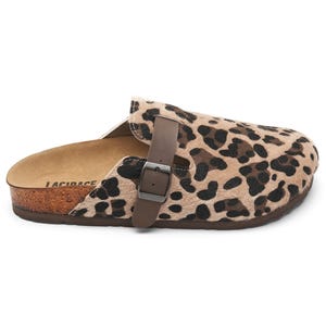 May include: A leopard print clog with a brown leather strap and buckle. The shoe has a cork sole and a soft, textured upper. The brand name "LACIDACE" is visible on the side of the shoe.