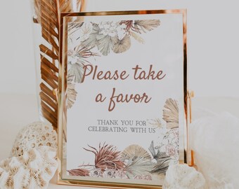 Può includere: Un cartello dorato con un disegno floreale e il testo "Per favore, prendi un favore. Grazie per aver festeggiato con noi."