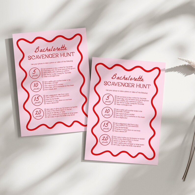 a pink paper with a red scalloped design on it