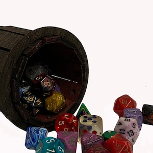 May include: A wooden dice tower with a red interior, spilling out a variety of colorful dice with different numbers and symbols. The dice are made of various materials, including plastic, metal, and glass.