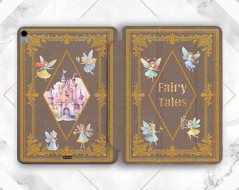 May include: A brown iPad case with a fairy tale theme. The case features a castle illustration, fairies, and the words "Fairy Tales." Gold filigree frames the design. The case is open, revealing the iPad screen.