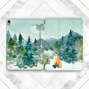 May include: A watercolor illustration of a snowy forest scene with a fox in the foreground. The fox is orange and white and is sitting in the snow. The forest is made up of tall, green pine trees and the background is a mountain range. The sky is blue and there are snowflakes falling.