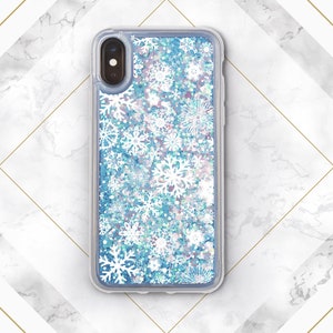 May include: A clear phone case with a blue glitter background and white snowflake pattern.