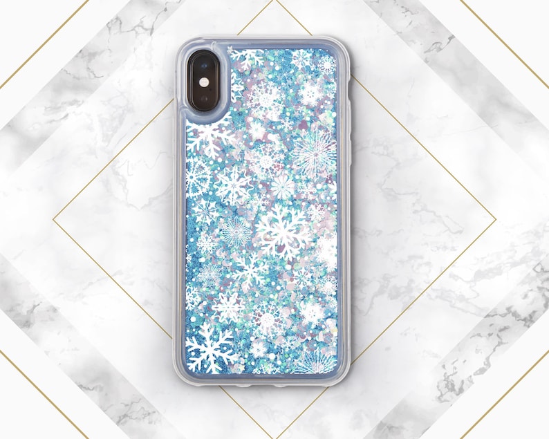 May include: A clear phone case with a blue glitter background and white snowflake pattern.