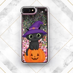 May include: A black cat wearing a purple witch hat sits on top of an orange pumpkin with a jack-o'-lantern face. The image is inside a clear phone case with glitter.