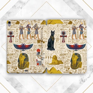 May include: A white background with a gold and black pattern of Egyptian hieroglyphs, gods, and symbols. The pattern includes a scarab beetle, an ankh, a pyramid, and a sphinx. The background is covered in handwritten text.