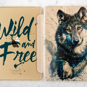 May include: A gold iPad case with a blue watercolor wolf design on the back. The front of the case has the text "Wild and Free" in blue.